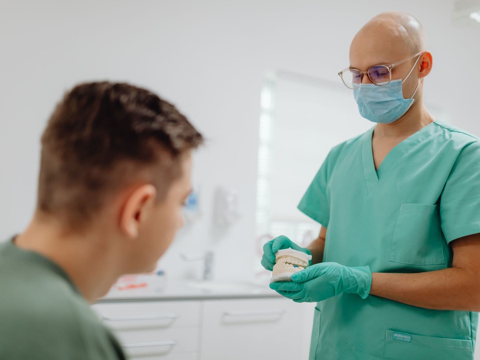 A dentist talking through treatment options with a patient